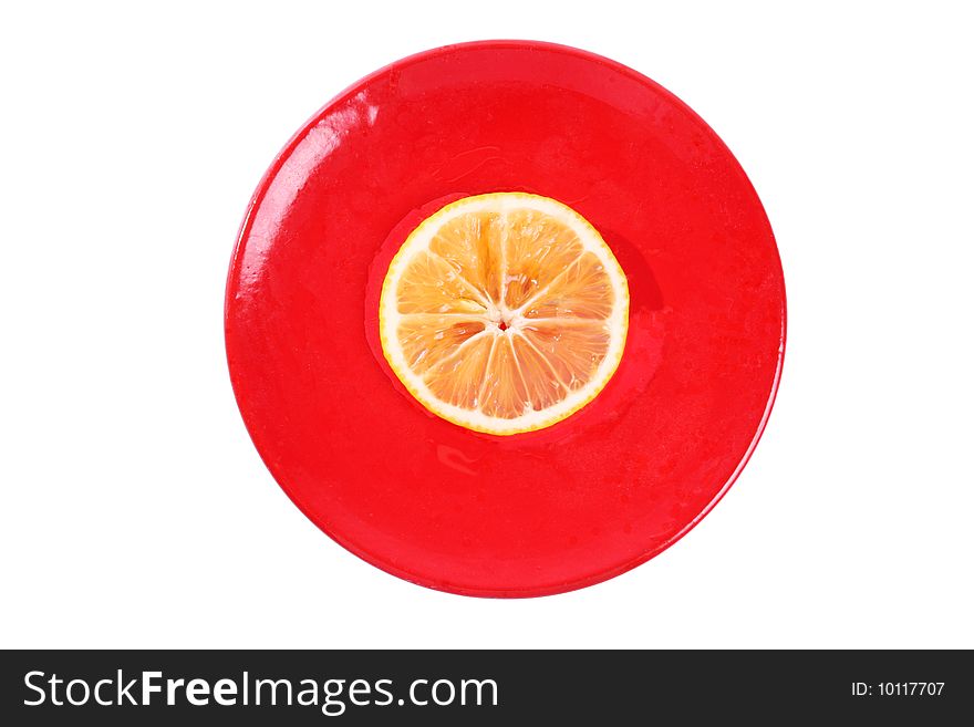 One slice of orange on a red plate isolated on white