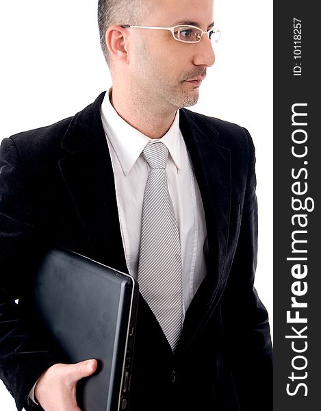 Businessman holding his laptop looking aside. Businessman holding his laptop looking aside