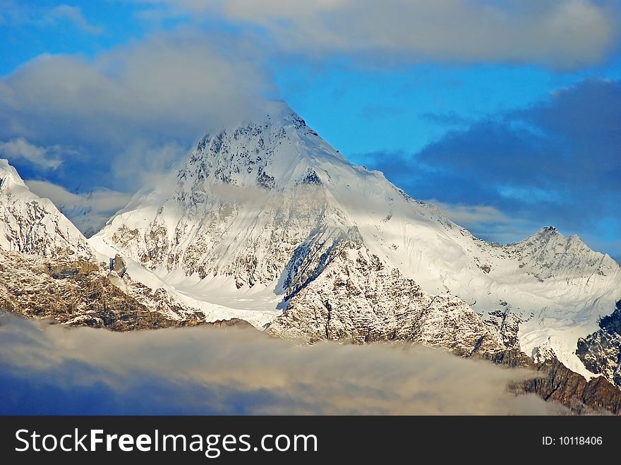 A high snowy mountain peak in china. A high snowy mountain peak in china