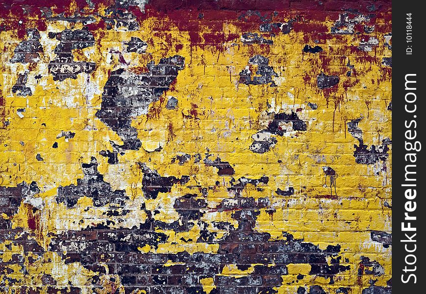 A old builiding wall with fading and chipping paint in New York City. A old builiding wall with fading and chipping paint in New York City