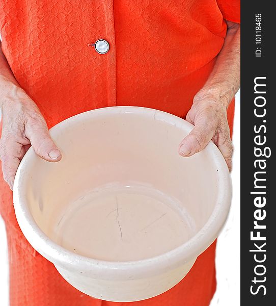 An old woman holding an empty plastic bucket. An old woman holding an empty plastic bucket