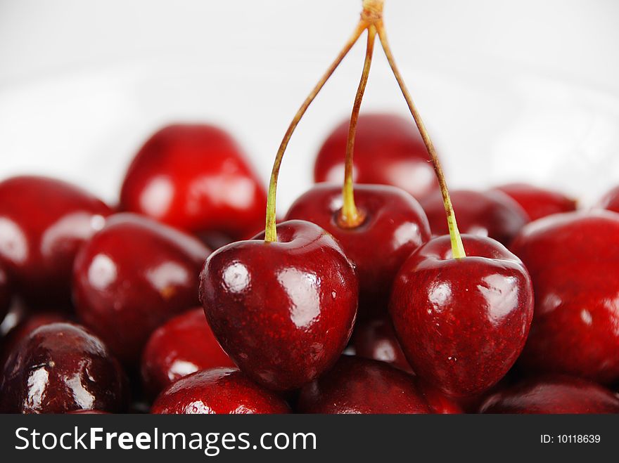 Three berries of cherry, connected by twigs on the berries of cherry without the twigs. Three berries of cherry, connected by twigs on the berries of cherry without the twigs