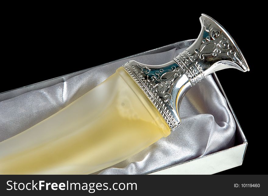 A stylish perfume bottle with silver cap