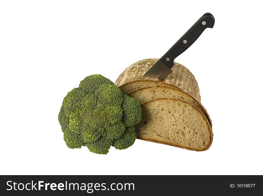 Loaf of bread with knife and broccoli isolated over white background