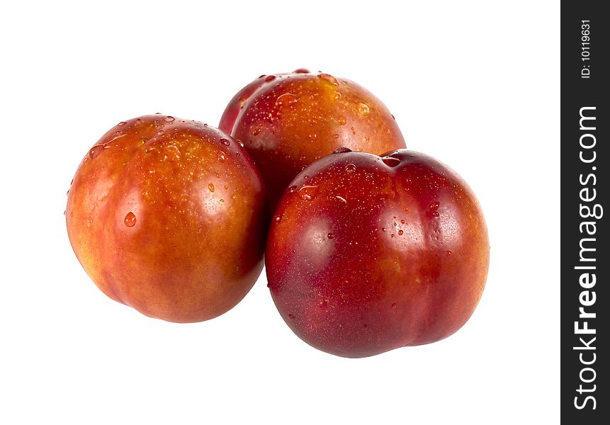 Three wet peaches isolated over white background