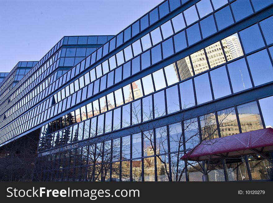 Blue glass building with reflections and many angles