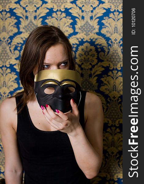 Portrait beautiful girl with mask on yellow background