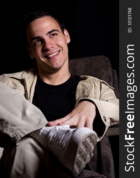 Young man smiling, isolated on black