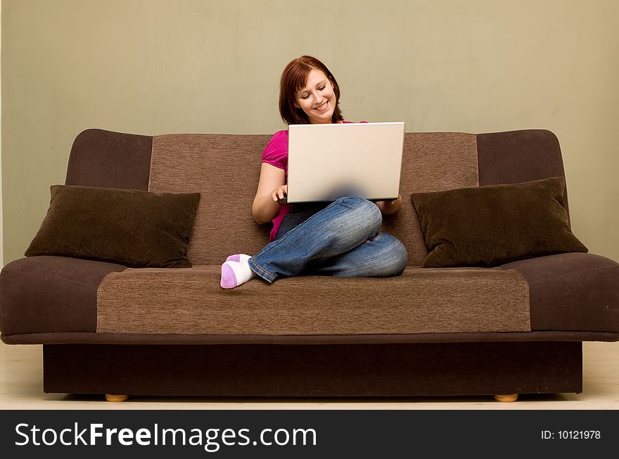 Woman with laptop on sofa