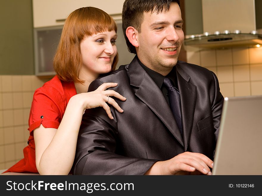 Happy couple in kitchen with laptop. Happy couple in kitchen with laptop