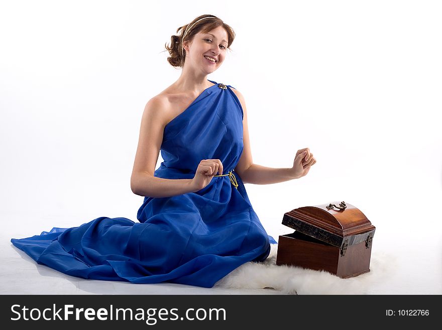 Lady in blue antique dress opening box on white background. Lady in blue antique dress opening box on white background