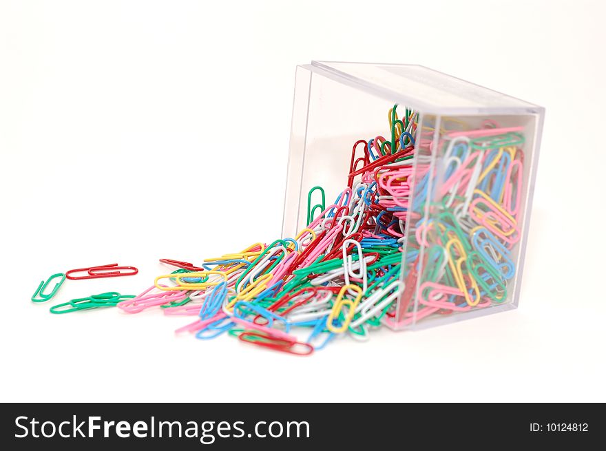 Paperclips spilled over in a container.