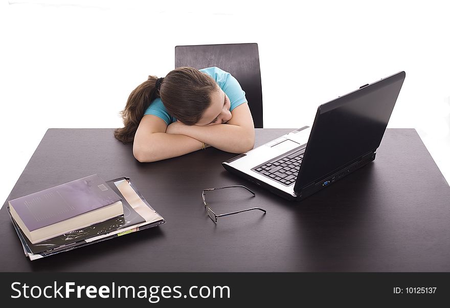A young girl sleeping on the laptop