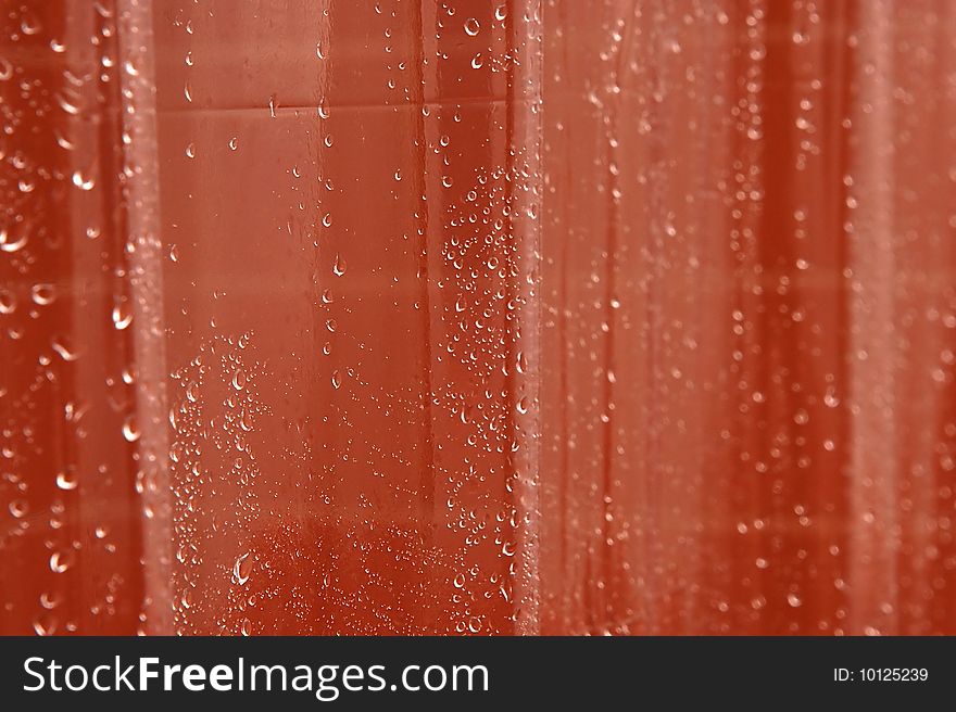 Clear wet shower curtain with tiles in background. Clear wet shower curtain with tiles in background