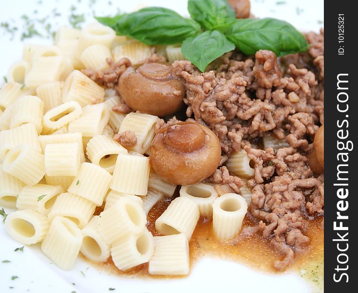 A meal with meat, mushrooms and noodles