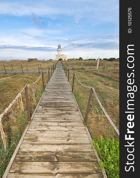 An emotional landscape with lighthouse in the green, sky and clouds add a dramatic sense. An emotional landscape with lighthouse in the green, sky and clouds add a dramatic sense