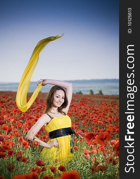 Attractive girl in yellow dress in the poppy field. Attractive girl in yellow dress in the poppy field