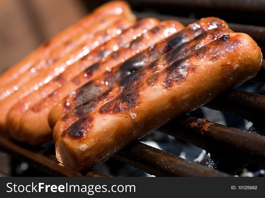 Hotdogs on the grill outdoor on a small grill