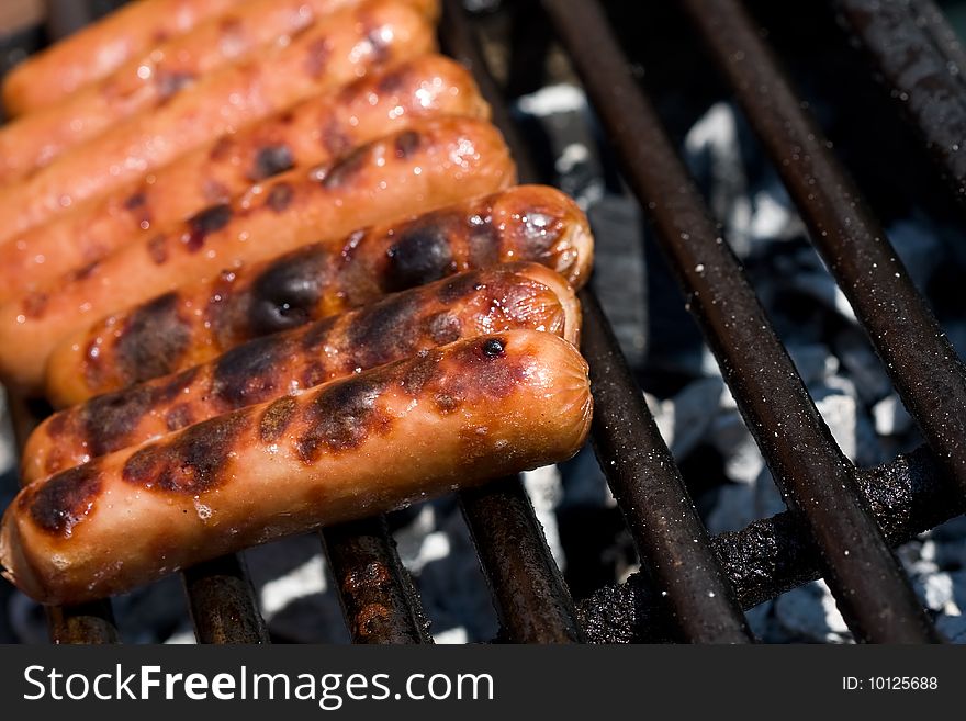 Hotdogs on the grill outdoor on a small grill