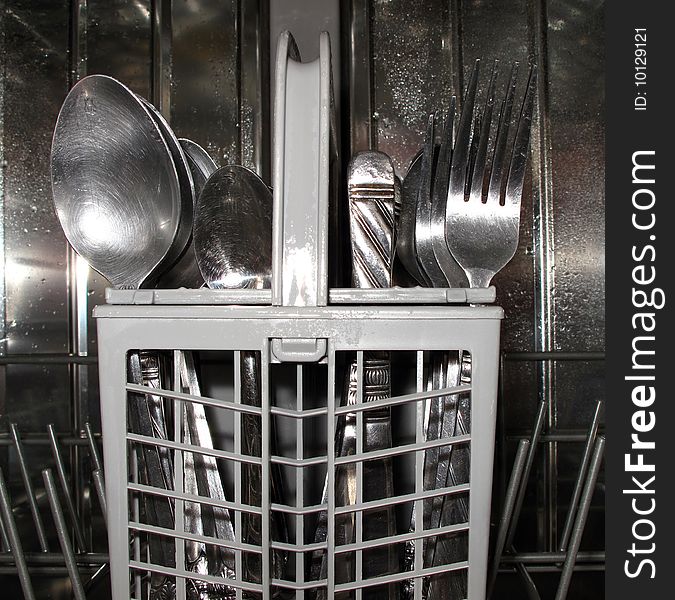 Close-up of utlery basket in dishwasher. Close-up of utlery basket in dishwasher