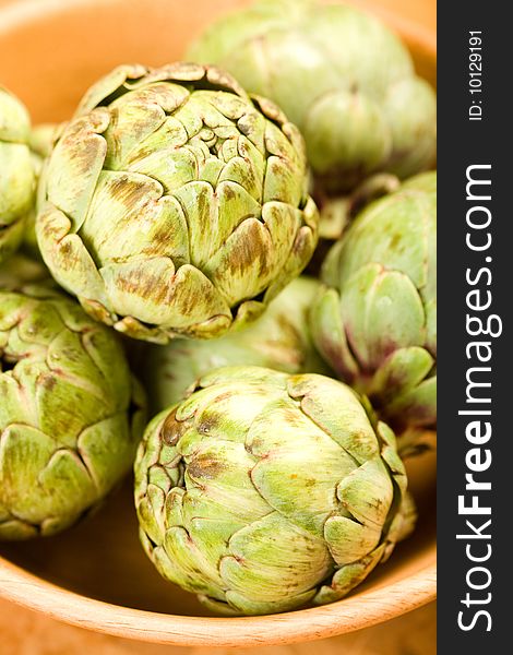 Baby artichokes in wooden bowl