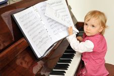 Girl Plays  Piano Stock Photos