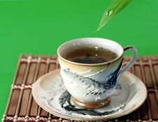 A Cup Of Green Tea And A Drop Of Water Stock Images A Cup Of Green Tea And A Drop Of Water Stock Images