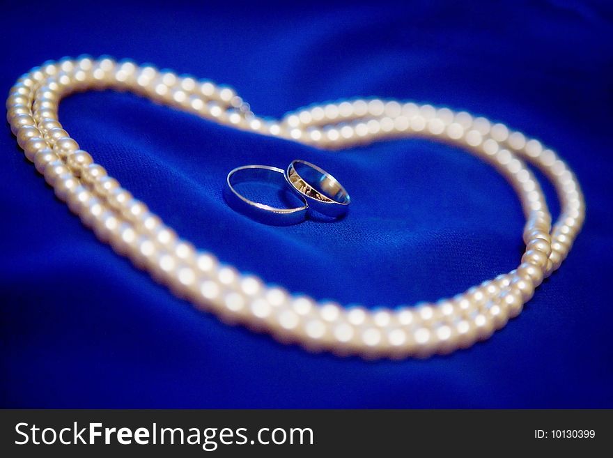 Macro of beautiful pearl necklace and rings. Macro of beautiful pearl necklace and rings