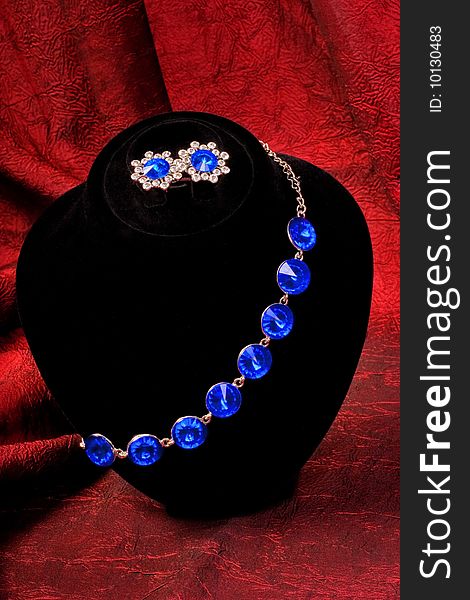 Bracelet with blue gem on black stand