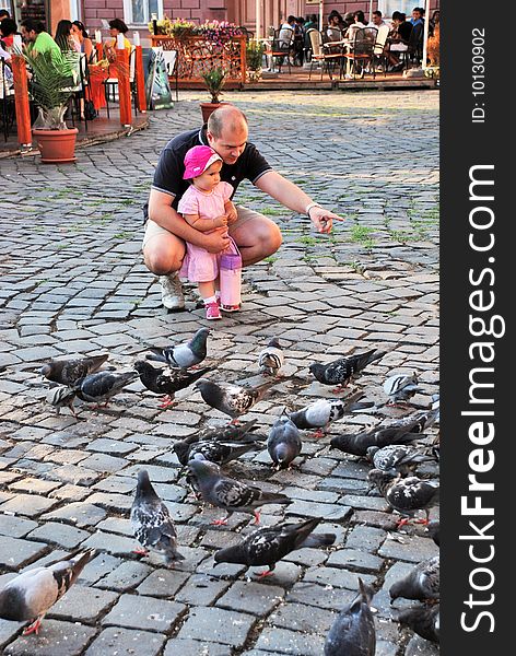 A portrait with beautiful little girl and her dad playing with dove. A portrait with beautiful little girl and her dad playing with dove