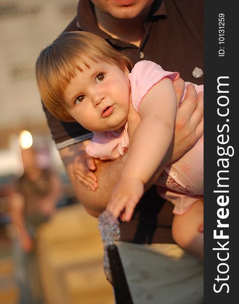 A portrait with beautiful little girl in father's arms. A portrait with beautiful little girl in father's arms