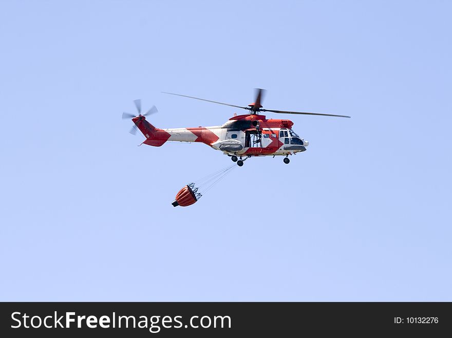 A South African Air Force Oryx firefighting helicopter with a fire bucket at Ysterplaat Air Force Base Cape Town South. A South African Air Force Oryx firefighting helicopter with a fire bucket at Ysterplaat Air Force Base Cape Town South