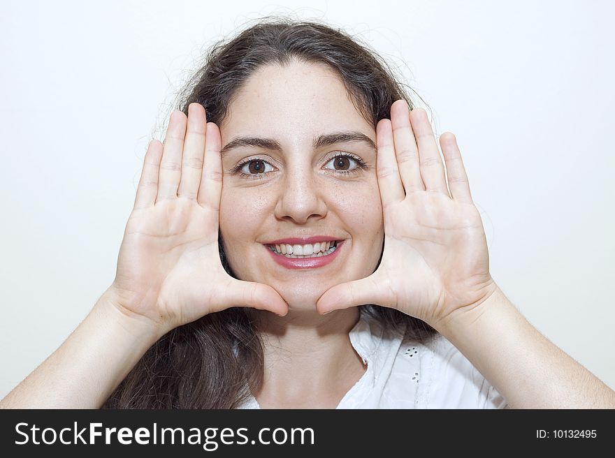 Young woman framing her face with hands