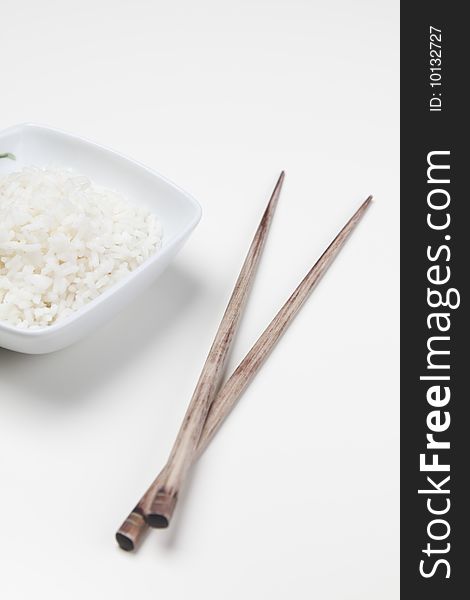 A bowl of perfectly cooked, plain Basmati rice, in an Asian style bowl, with a garnish of Thai Basil. A bowl of perfectly cooked, plain Basmati rice, in an Asian style bowl, with a garnish of Thai Basil