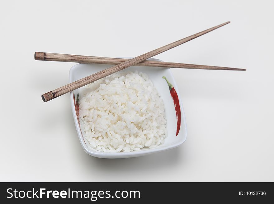 A bowl of perfectly cooked, plain Basmati rice, in an Asian style bowl, with a garnish of Thai Basil. A bowl of perfectly cooked, plain Basmati rice, in an Asian style bowl, with a garnish of Thai Basil