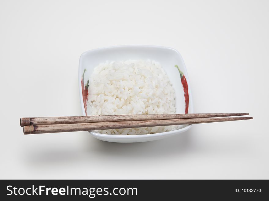 A bowl of perfectly cooked, plain Basmati rice, in an Asian style bowl, with a garnish of Thai Basil. A bowl of perfectly cooked, plain Basmati rice, in an Asian style bowl, with a garnish of Thai Basil