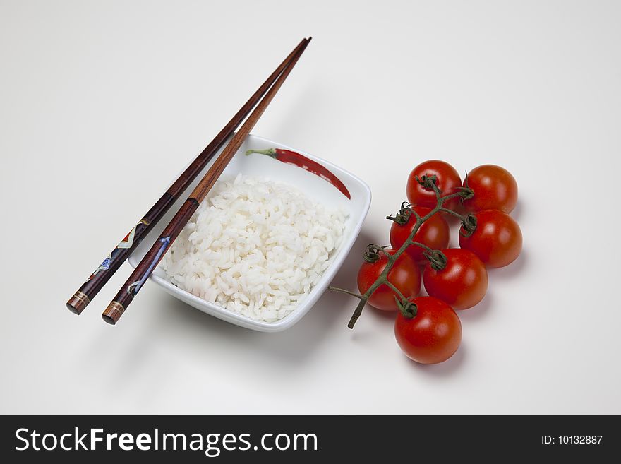 A bowl of perfectly cooked, plain Basmati rice, in an Asian style bowl, with a garnish of Thai Basil. A bowl of perfectly cooked, plain Basmati rice, in an Asian style bowl, with a garnish of Thai Basil