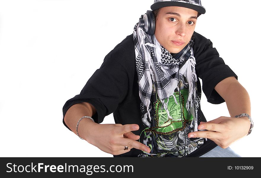 A young DJ is pointing up. He is listening to music on his headphones! Isolated over white. A young DJ is pointing up. He is listening to music on his headphones! Isolated over white.