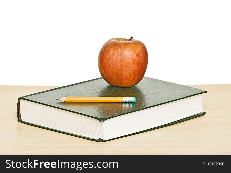 Apple And Pencil On Top Of Book