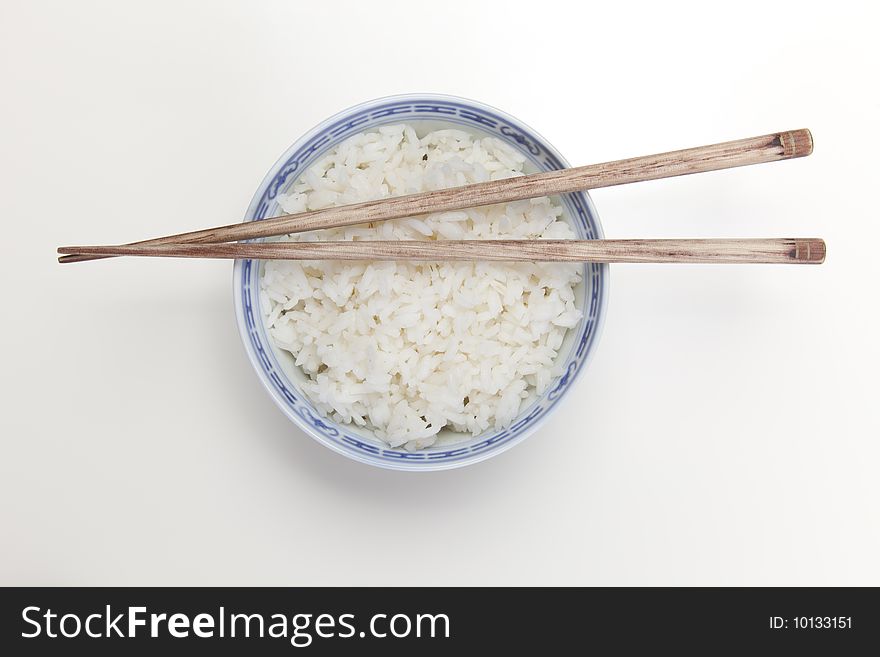 A bowl of perfectly cooked, plain Basmati rice, in an Asian style bowl, with a garnish of Thai Basil. A bowl of perfectly cooked, plain Basmati rice, in an Asian style bowl, with a garnish of Thai Basil