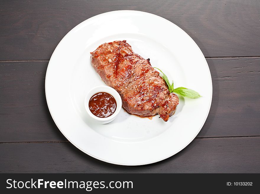 Juicy beef steak with sauce and oregano