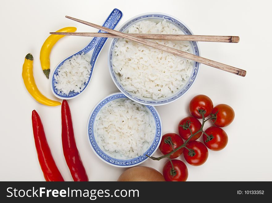 A bowl of perfectly cooked, plain Basmati rice, in an Asian style bowl, with a garnish of Thai Basil. A bowl of perfectly cooked, plain Basmati rice, in an Asian style bowl, with a garnish of Thai Basil