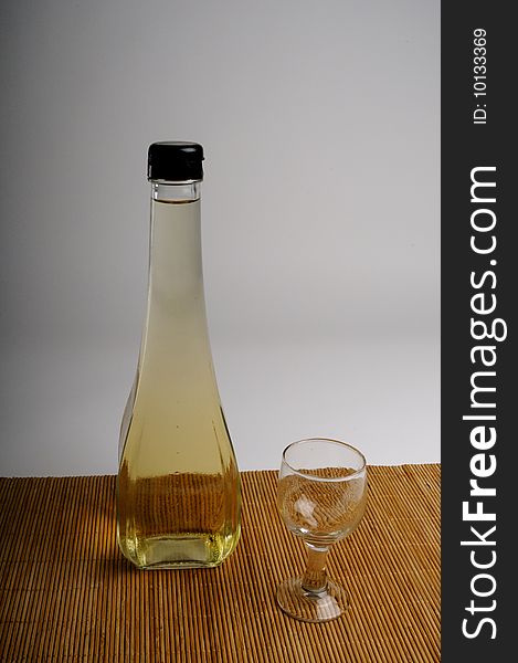 Close up of bottle with vinegar and transparent glass