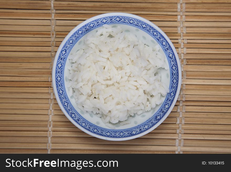 A bowl of perfectly cooked, plain Basmati rice, in an Asian style bowl, with a garnish of Thai Basil. A bowl of perfectly cooked, plain Basmati rice, in an Asian style bowl, with a garnish of Thai Basil