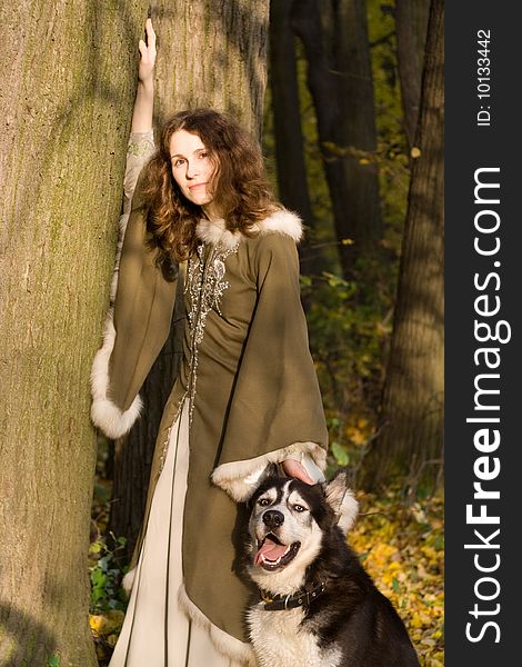 Lady in medieval dress and dog in the forest. Lady in medieval dress and dog in the forest