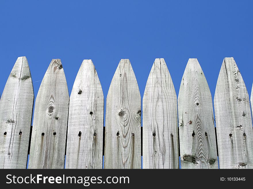 Wooden fence in a blue sky