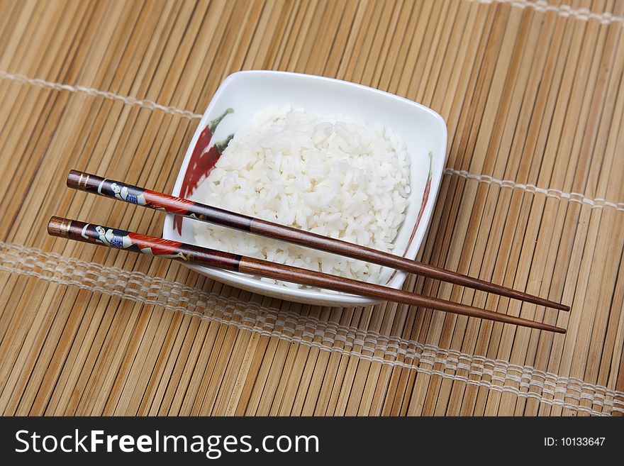 A bowl of perfectly cooked, plain Basmati rice, in an Asian style bowl, with a garnish of Thai Basil. A bowl of perfectly cooked, plain Basmati rice, in an Asian style bowl, with a garnish of Thai Basil