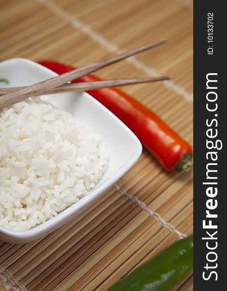 A bowl of perfectly cooked, plain Basmati rice, in an Asian style bowl, with a garnish of Thai Basil. A bowl of perfectly cooked, plain Basmati rice, in an Asian style bowl, with a garnish of Thai Basil