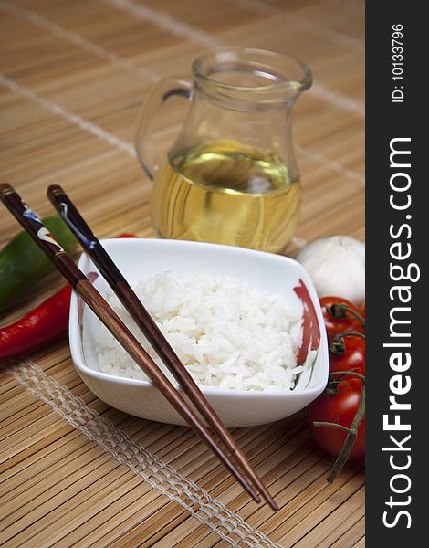 A bowl of perfectly cooked, plain Basmati rice, in an Asian style bowl, with a garnish of Thai Basil. A bowl of perfectly cooked, plain Basmati rice, in an Asian style bowl, with a garnish of Thai Basil