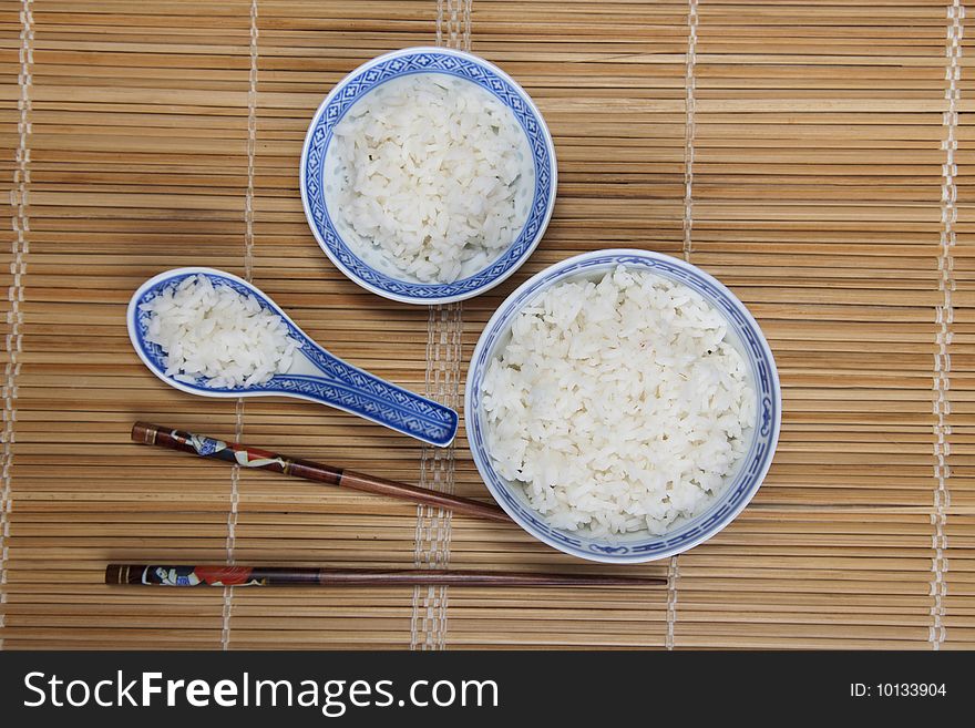 A bowl of perfectly cooked, plain Basmati rice, in an Asian style bowl, with a garnish of Thai Basil. A bowl of perfectly cooked, plain Basmati rice, in an Asian style bowl, with a garnish of Thai Basil